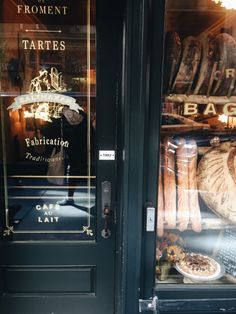 the front door of a restaurant with bread and pastries