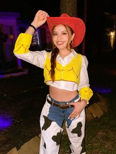 a woman dressed up as a cowgirl posing for the camera