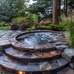 an outdoor hot tub surrounded by stone steps