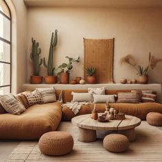 a living room filled with lots of furniture and potted plants on top of it