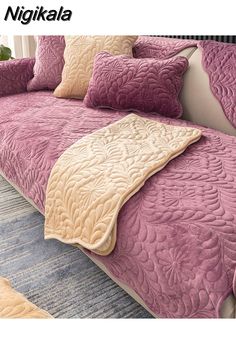 an image of a bed that is made up with purple and tan sheets on it