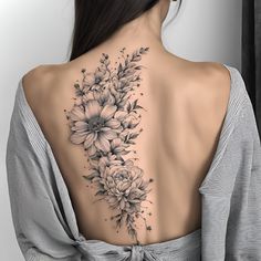 the back of a woman's neck with flowers on it