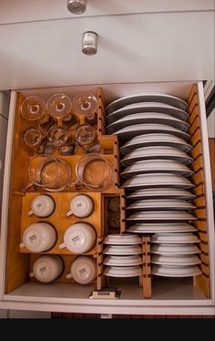 a cabinet filled with lots of dishes and plates