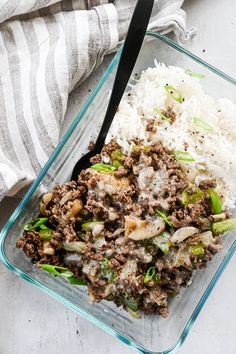 a glass dish filled with rice and ground beef