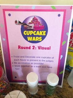 cupcake wars round 2 visual sign in front of candy and confetti cups