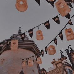 some lights hanging from the side of a building