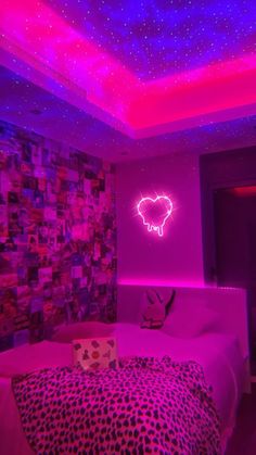 a bedroom with pink and purple lights on the ceiling