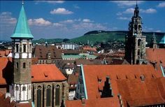 an aerial view of the city with red roofs and steeple spires in europe