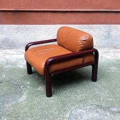 a brown chair sitting on top of a cement floor