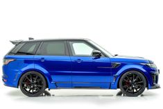 the blue range rover is parked in front of a white background with black rims