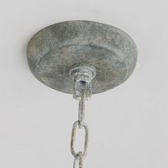 an old light fixture with chain hanging from it