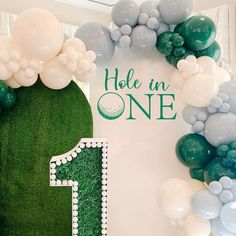 a green and white birthday backdrop with balloons