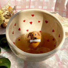 a bowl filled with liquid and a dog figurine in it