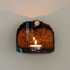 a candle is lit in the middle of a wall