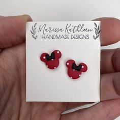 a pair of red and black minnie mouse earrings