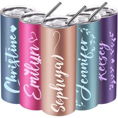 four different colored cans with straws in them