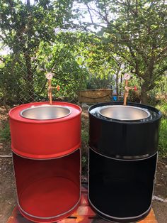 two black and red barrels sitting next to each other