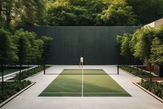 a man standing on top of a tennis court holding a racquet in his hand