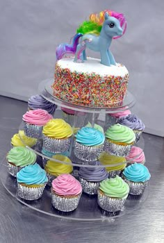 cupcakes are stacked on top of each other in the shape of a unicorn