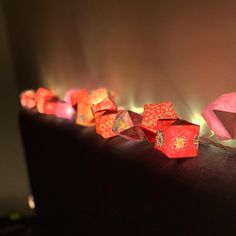 some red and orange cubes sitting on top of a black table with flames in the background