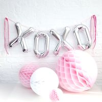 some balloons are hanging on the wall with letters that spell out yook and two balls