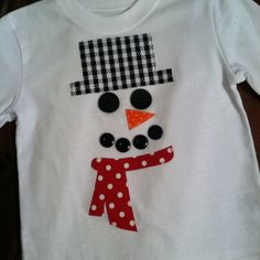 a white shirt with a snowman on it's chest and polka dots around the neck