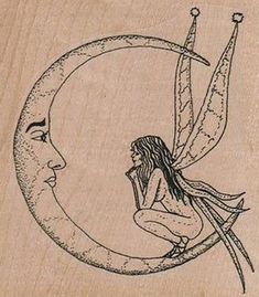 a wooden stamp with a fairy sitting on the moon and holding a knife in it's hand