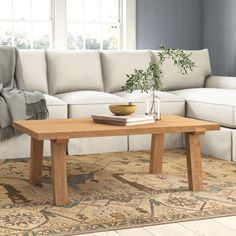 a living room with a couch, coffee table and rug