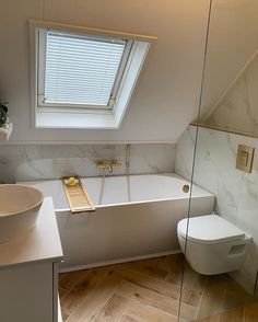 a bathroom with a skylight, toilet and bathtub in the middle of it