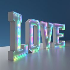 the word love is made up of multicolored letters on a white surface with a blue background