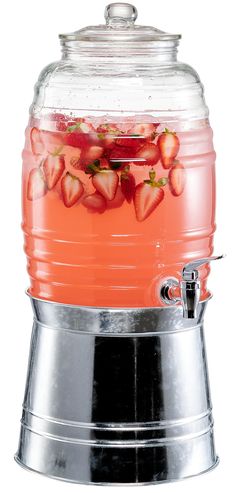 a large glass jar filled with liquid and strawberries