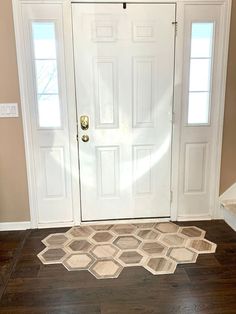 a white door with two windows and a rug on the floor