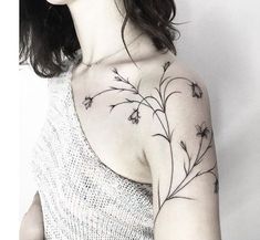 a woman with a flower tattoo on her shoulder