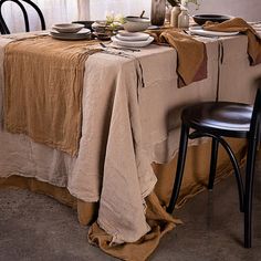 the table is set with plates and bowls