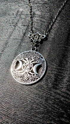 a silver necklace with an intricate design on it