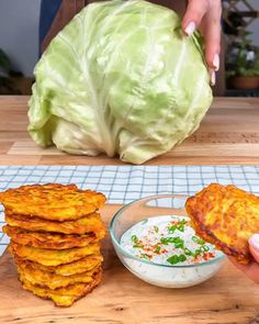 a person is cutting up some food on a wooden board and it looks like cabbage