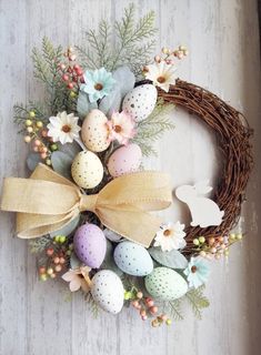 an easter wreath with eggs and flowers