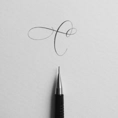 the letter f is written in cursive writing with a fountain pen on top of it