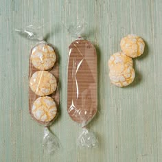 four cookies wrapped in cellophane and sitting next to each other on a table