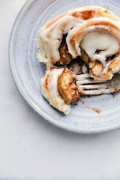 a plate that has some kind of pastry on it with a fork sticking out of it