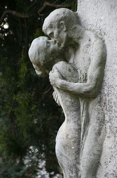 a statue of a man and woman hugging each other