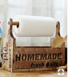 an old fashioned wooden box with some toilet paper and other items on top of it