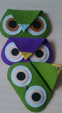 two owls made out of felt sitting next to each other