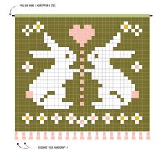 a cross stitch pattern with two white rabbits on green and pink squares in the shape of hearts