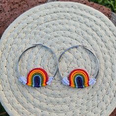 two hoop earrings with rainbows on them