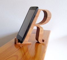 a cell phone sitting on top of a wooden stand