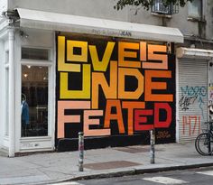 a bicycle parked in front of a building with graffiti on it