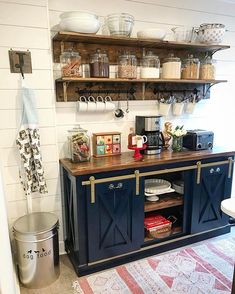 the inside of a kitchen with shelves, cabinets and other items on display in it