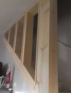 the stairs are made from wood and have been built into the wall to allow for storage