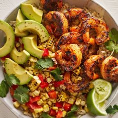 a bowl filled with shrimp, corn and avocado